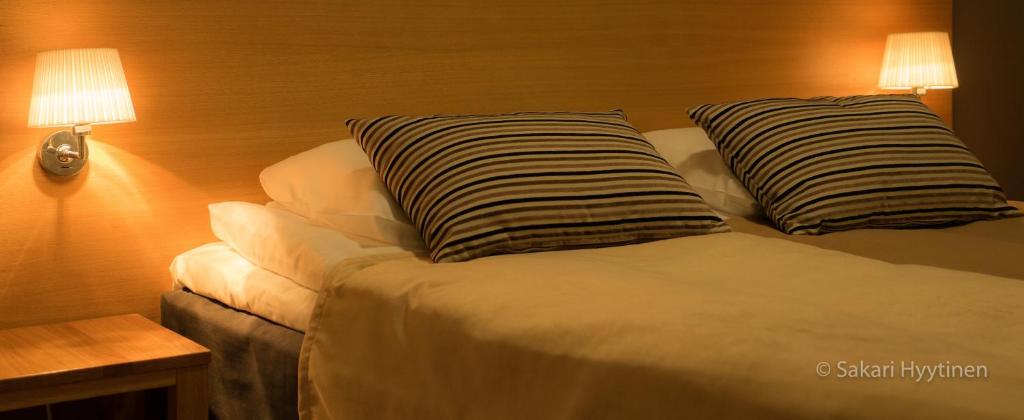 Кровать или кровати в номере Ruka Chalets Ski-Inn