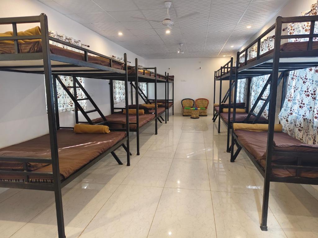 a group of bunk beds in a room at The Rishi Van Dormitory, Khetri,Rajasthan,Farm No 52-55,Vally Drive,Retreat Nature Farms Society Complex in Khetri