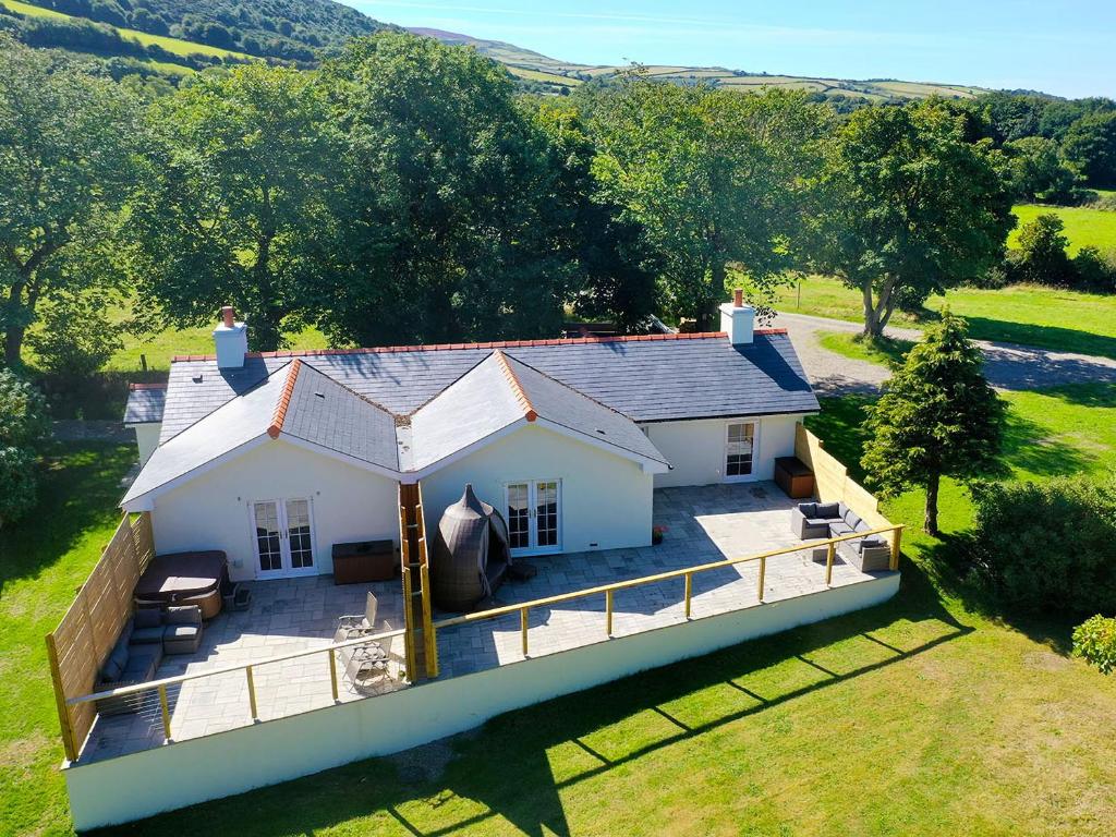 an aerial view of a white house with a porch at Dragonfly Cottage-Uk39919 in Ballakinnag