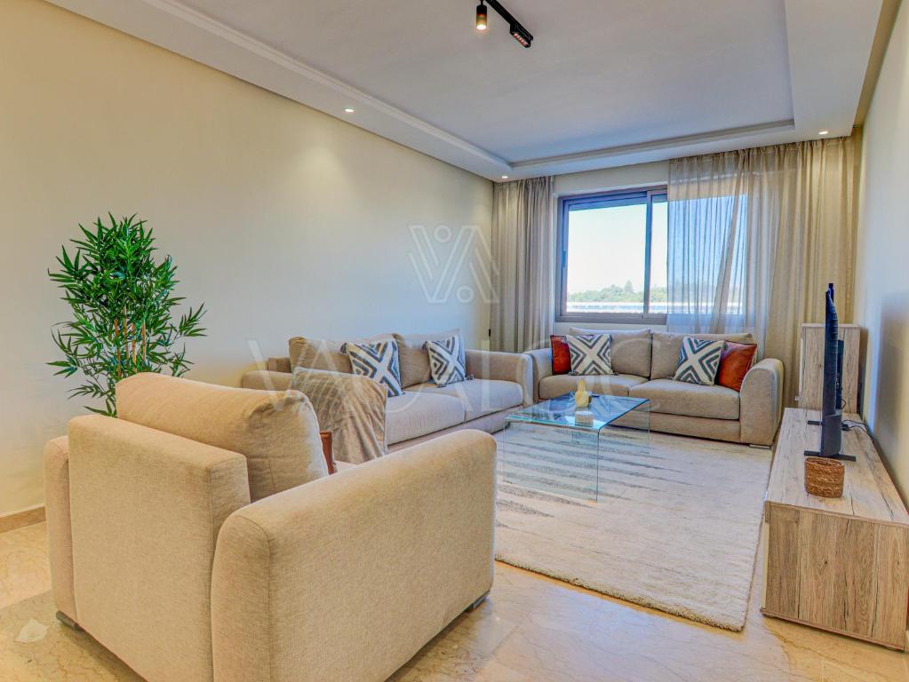 a living room with two couches and a tv at Iris Agadir - Luxe - Piscine - 4 Px in Agadir
