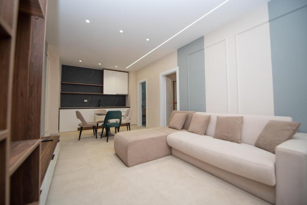 a living room with a white couch and a table at White Arena Apartments GOLEM in Golem