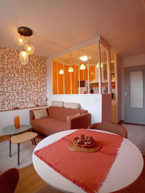 a living room with a couch and a table at La parenthèse 70's in Le Havre