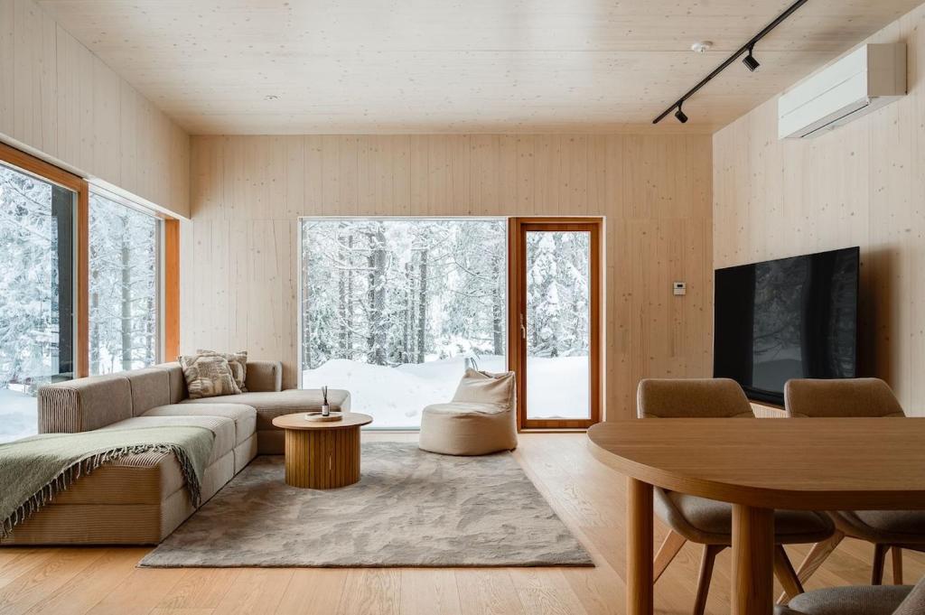 a living room with a couch and a table at Borderlake One in Ruka