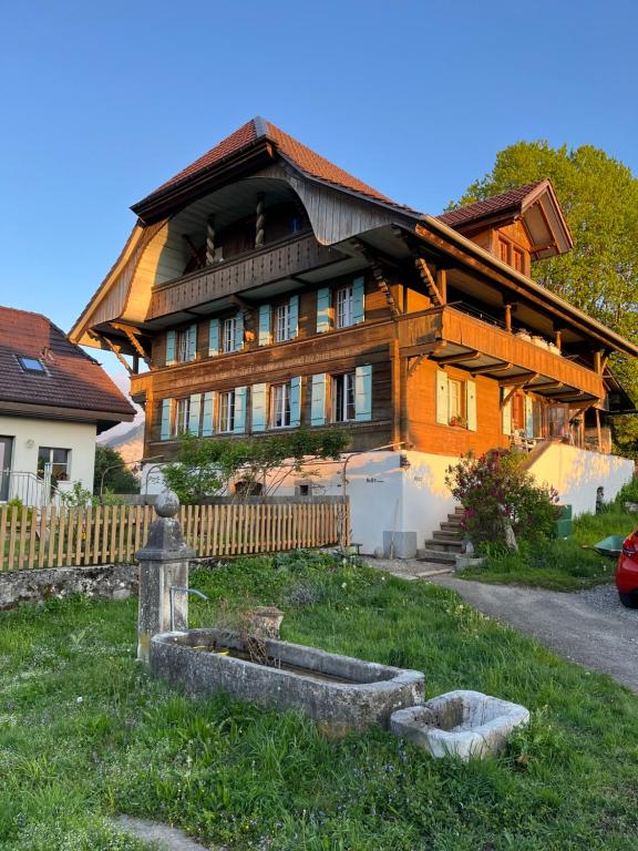 a large wooden house with a fence in front of it at BnB Haus Itten in Hondrich