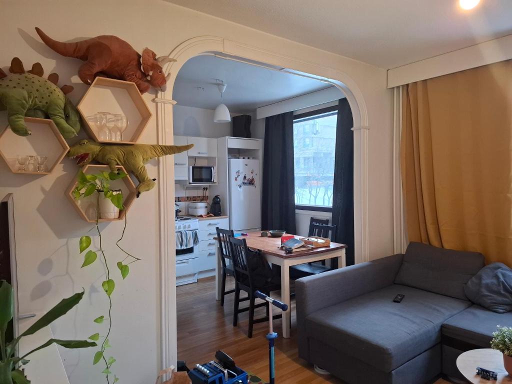 a living room with a couch and a table at Room near Tripla Pasila in Helsinki