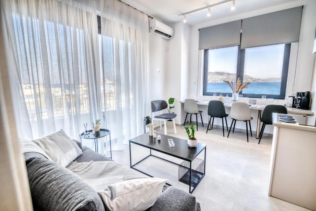 a living room with a couch and a table at Maison Poème Luxury Apartments in Aiándion