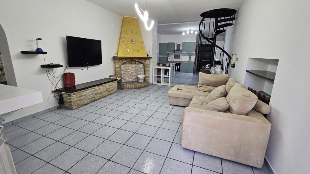 a living room with a couch and a fireplace at Casa Rosa in Rocca San Giovanni