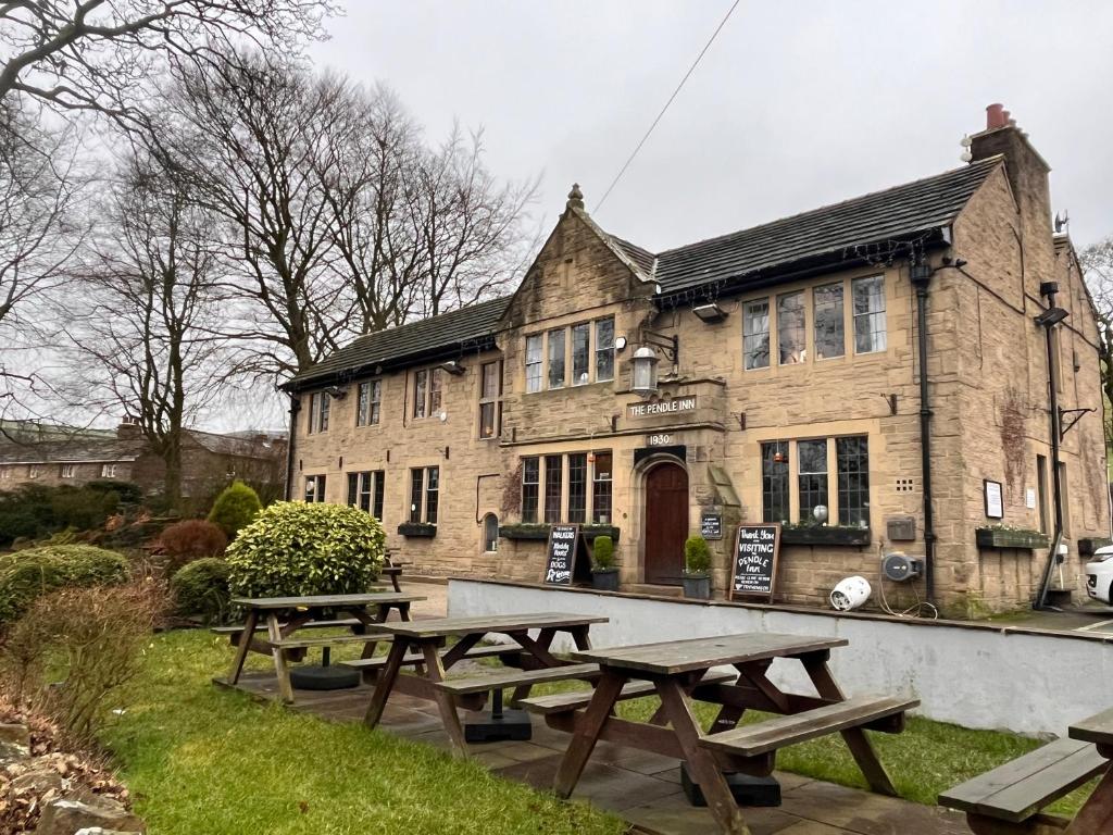 a group of picnic tables in front of a building at Pendle Inn in Barrowford