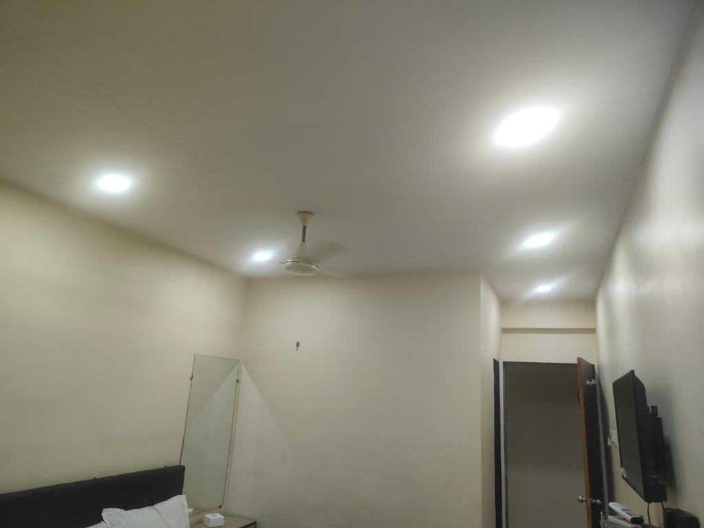 a room with a ceiling with a fan at kathiyawadi Hotel somnath in Kevdi Road