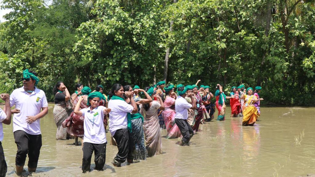 a group of people dancing in the water at Farm Shaala in Tiruttani