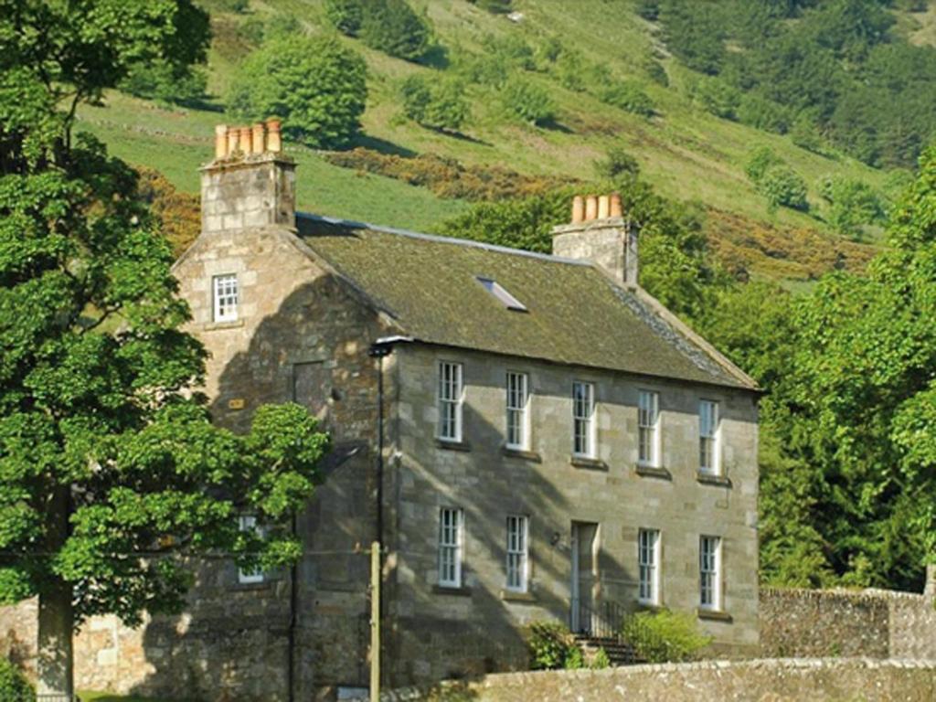 an old stone house on the side of a hill at Ladywell House in Falkland