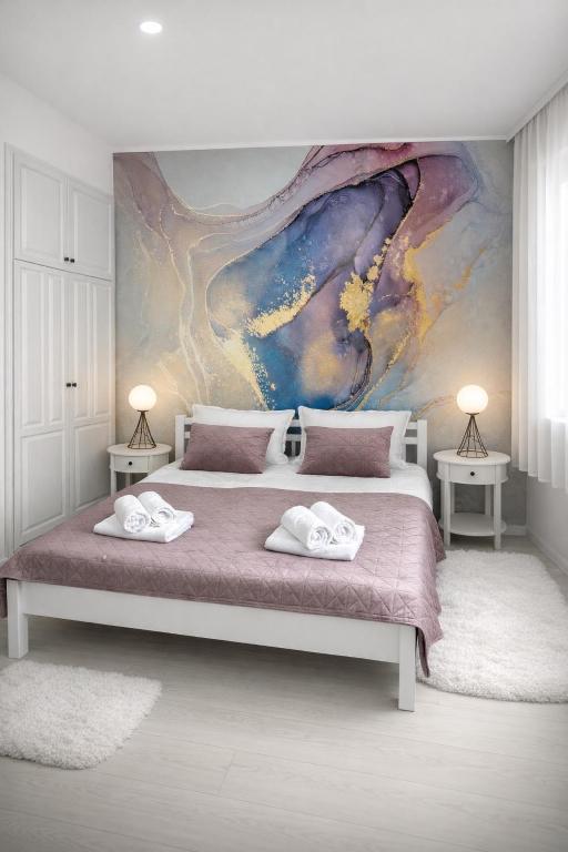 a bedroom with a large bed with two towels on it at Villa Una Maris - renovated 2026 in Pag