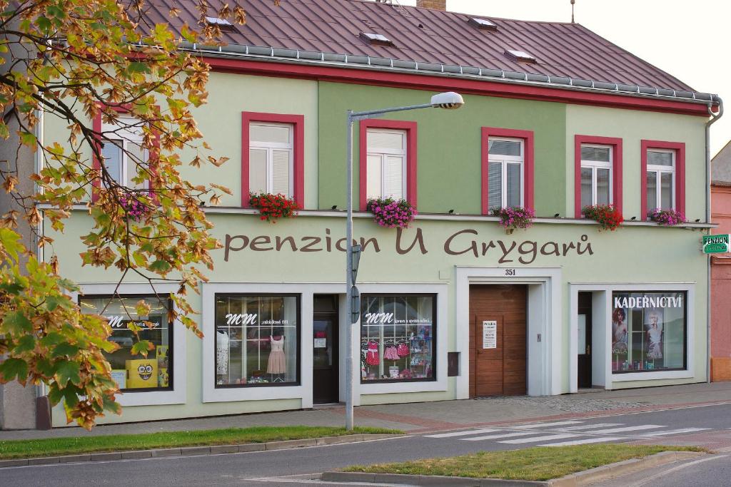a building with a sign on the front of it at Wellness penzion U Grygarů in Lipník nad Bečvou