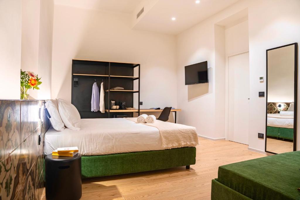 a bedroom with a large bed and a television at ARIA Collection Bari in Bari