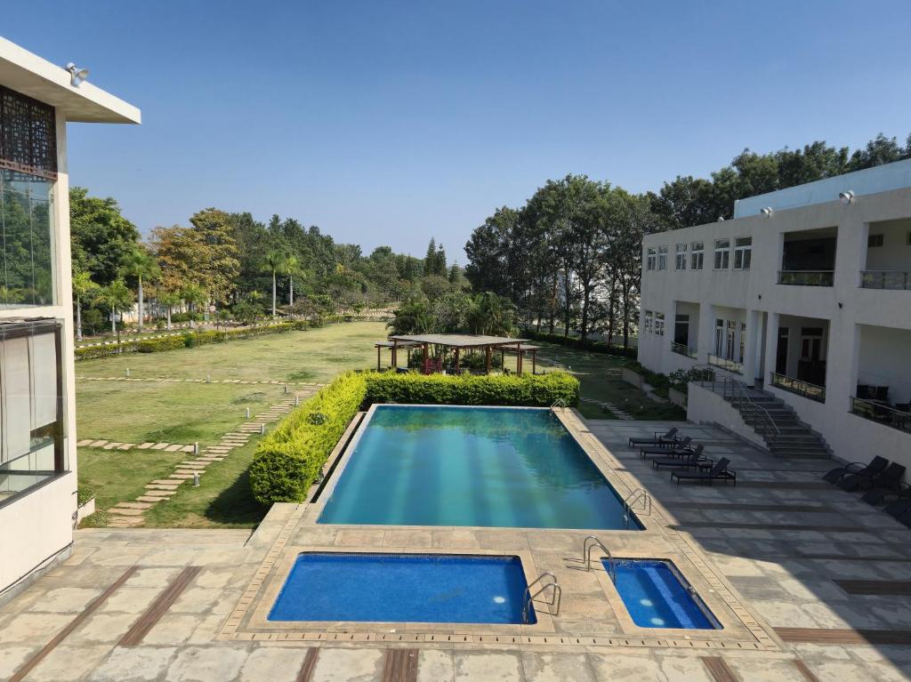 an overhead view of a swimming pool next to a building at Spree Resort At Century Wintersun in Dod Ballāpur