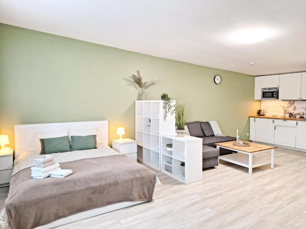 a bedroom with a bed and a living room at Dunes Trail 2 in Melnragė