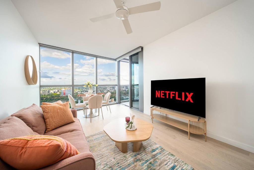 a living room with a netflix sign on a wall at Queens Wharf 1B plus Study apt - level 29 City view in Brisbane