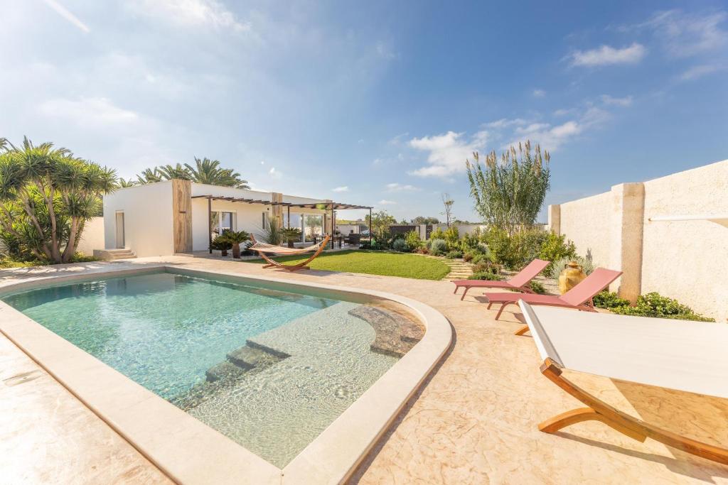 a swimming pool in the backyard of a house at Elisir Di Pace in Nardò