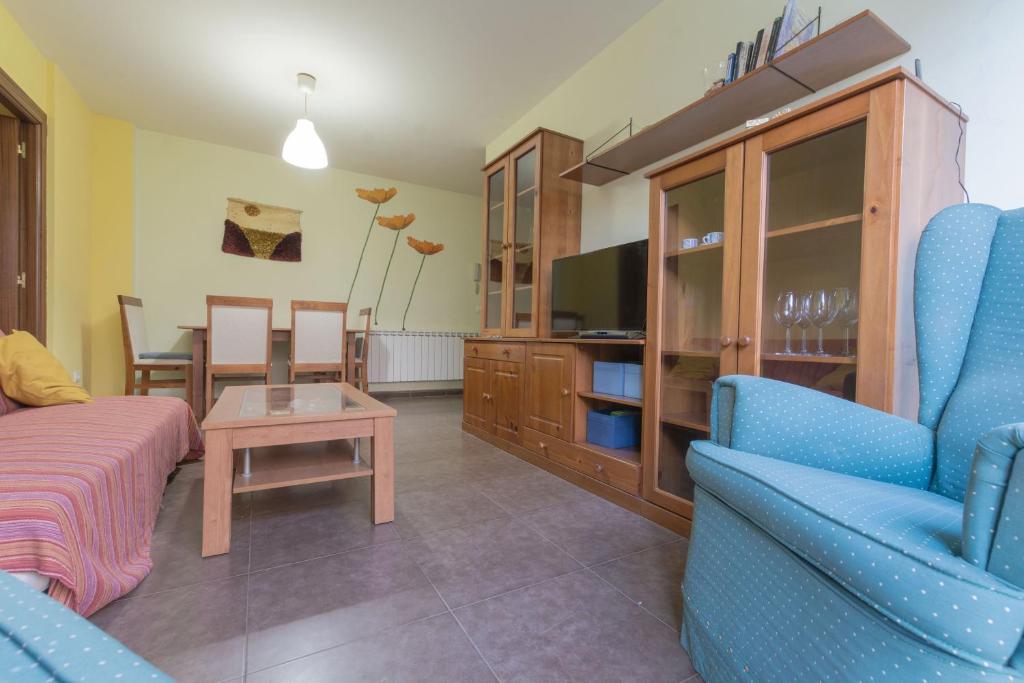 a living room with a couch and a tv at Gibaja Apartmento con Jardin in Gibaja