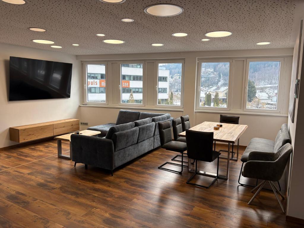 a living room with a couch and chairs and a table at Apartment Seeboden in Seeboden