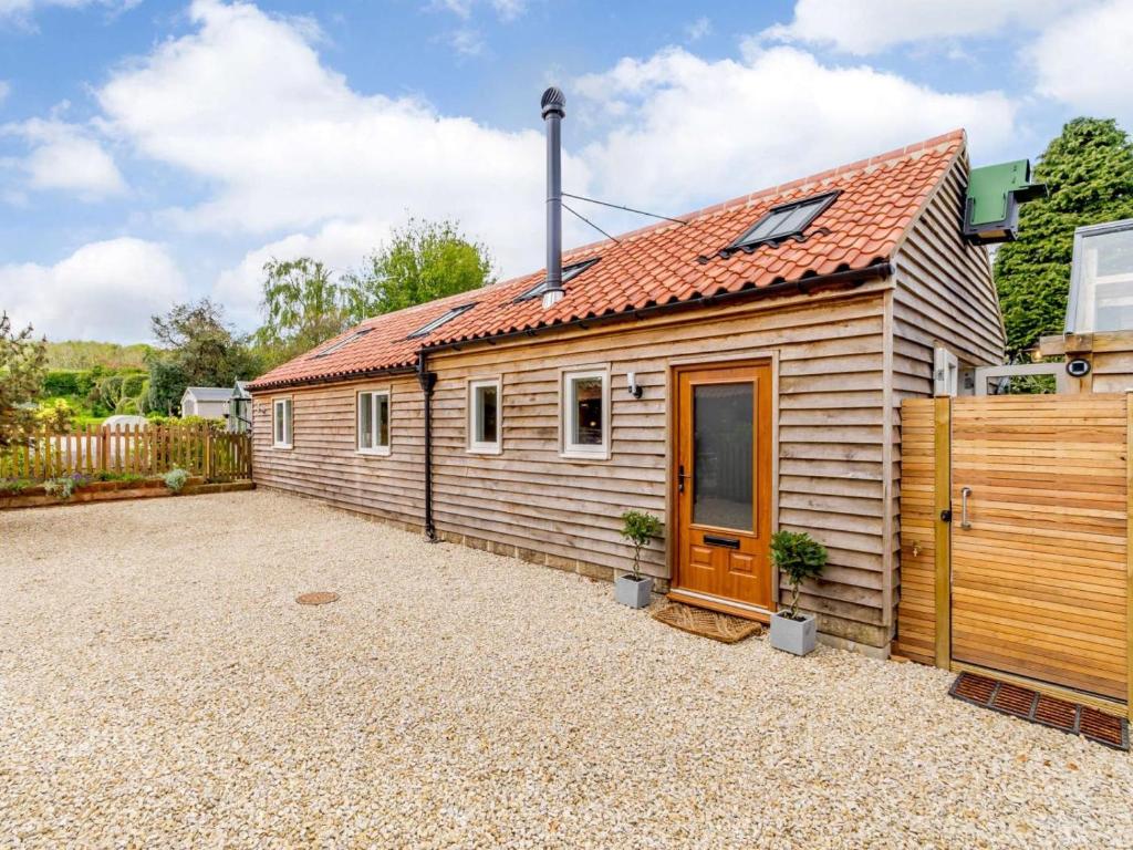 a small wooden cabin with a red roof at 2 Bed in York oc-81551 in Welburn