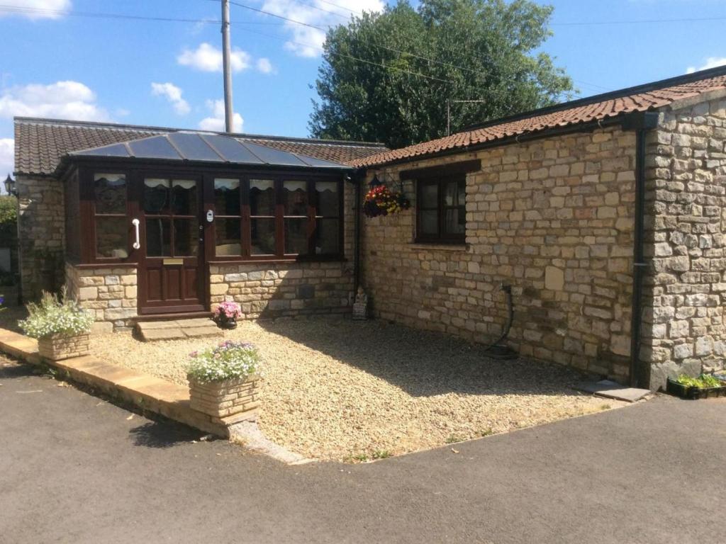 a brick building with a door and a window at 2 Bed in Chew Magna oc-56550 in Stowey