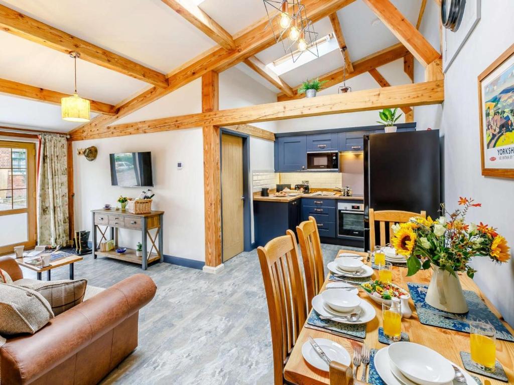 a living room with a table and a kitchen at 2 Bed in Ripon oc-85510 in Masham