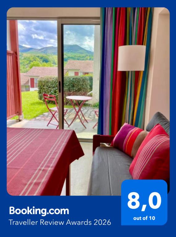 a room with a couch and a table and a window at MEHATCHE Piscine Vue Montagnes in Souraïde