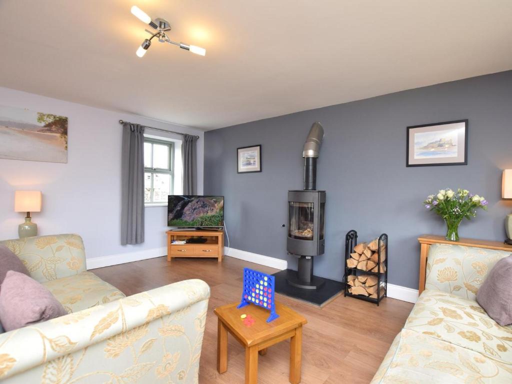 a living room with a couch and a wood stove at 2 Bed in Consett oc-smidc in Lanchester