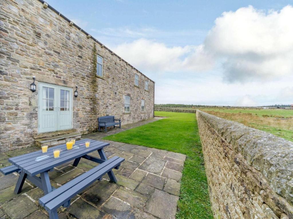 a blue picnic table in front of a brick building at 3 Bed in Consett oc-29408 in Lanchester