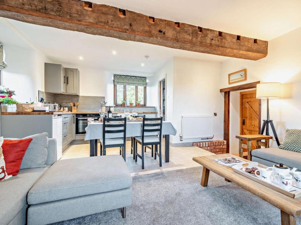 a living room with a couch and a table at 2 Bed in Taunton oc-93581 in Norton Fitzwarren