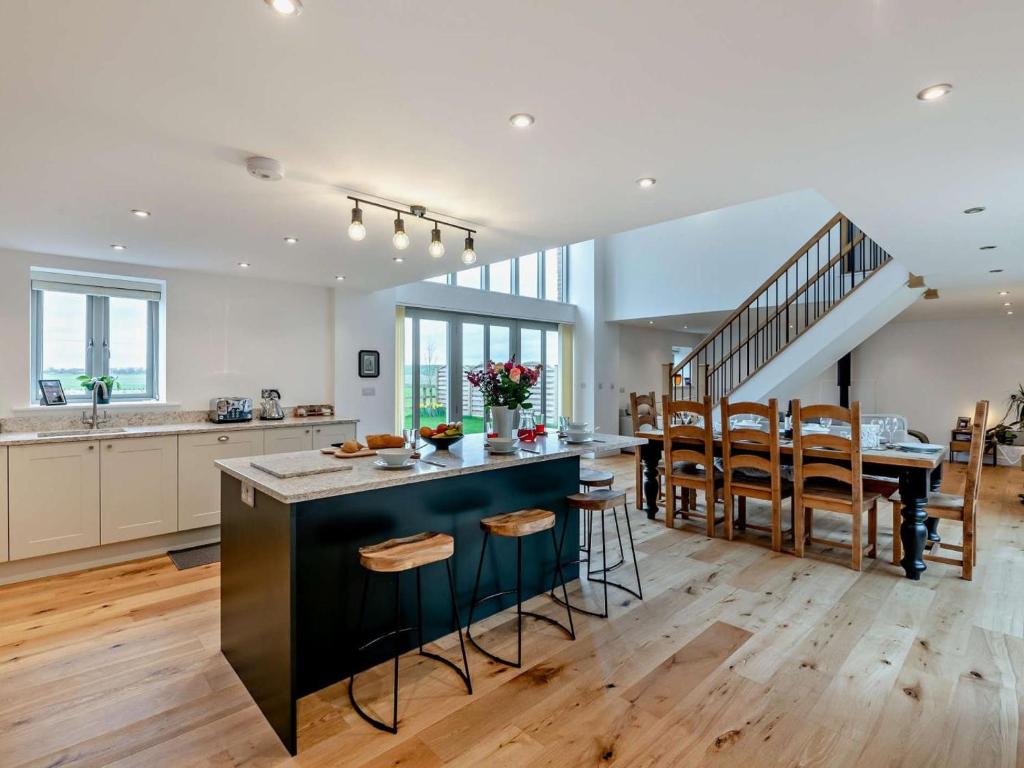a kitchen with a large island and a dining room at 4 Bed in Brough oc-93496 in Brough