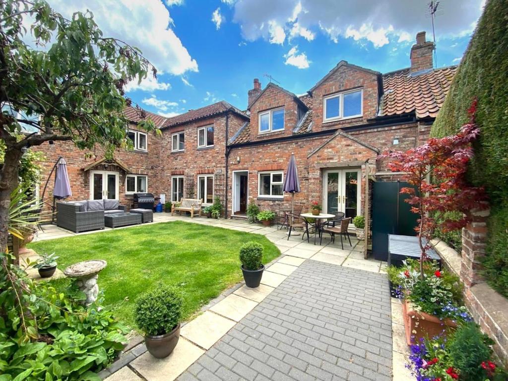 an exterior view of a house with a garden at 5 Bed in York oc-77267 in Green Hammerton