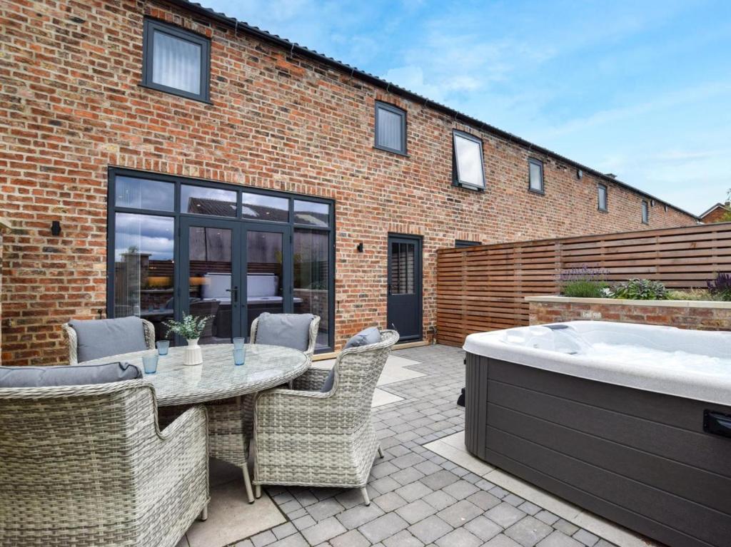 a patio with a table and a bath tub at 3 Bed in York oc-93896 in Tollerton