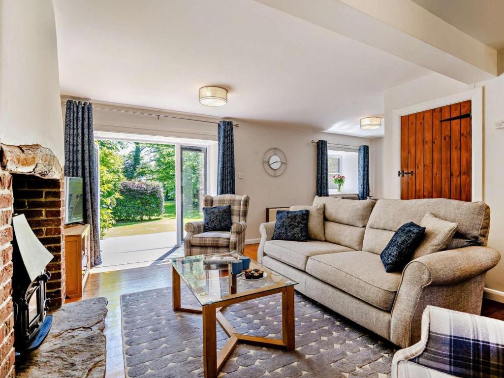 a living room with a couch and a table at 3 Bed in Dorchester oc-92414 in Frome Vauchurch