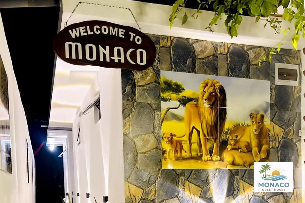 a sign that reads welcome to monaco on a wall at Monaco Guest House in Devinuwara
