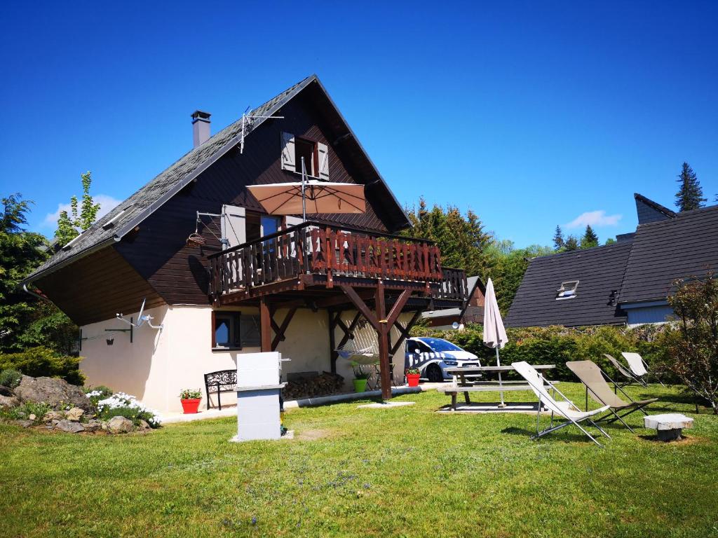 a house with a balcony and a deck at chalet besse en chandese in Besse-et-Saint-Anastaise