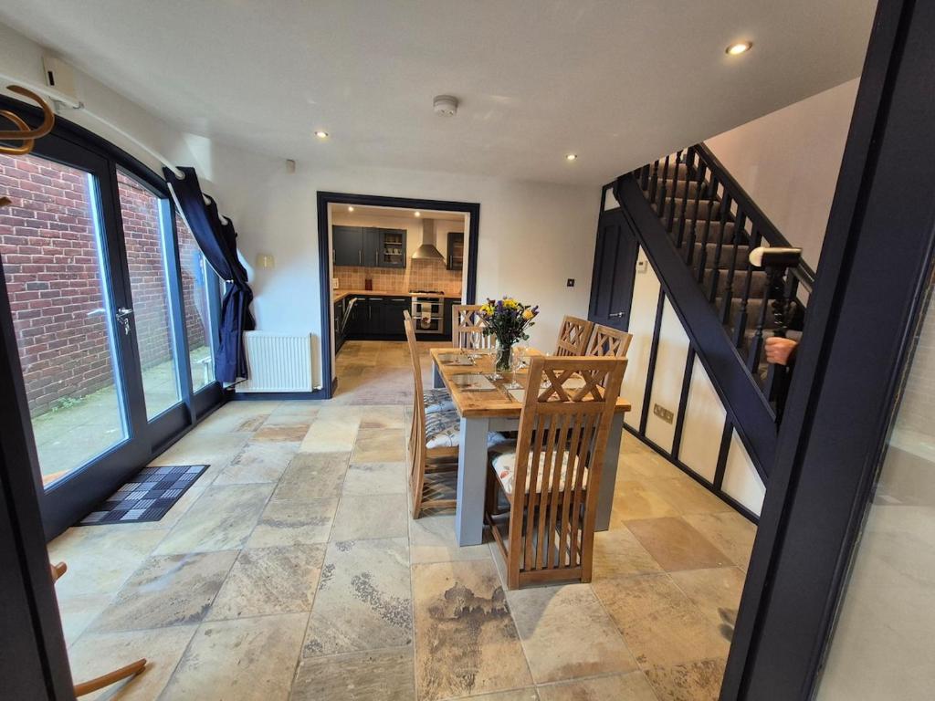 a kitchen and dining room with a table and chairs at The Old Mill - Ripon Centre in Ripon