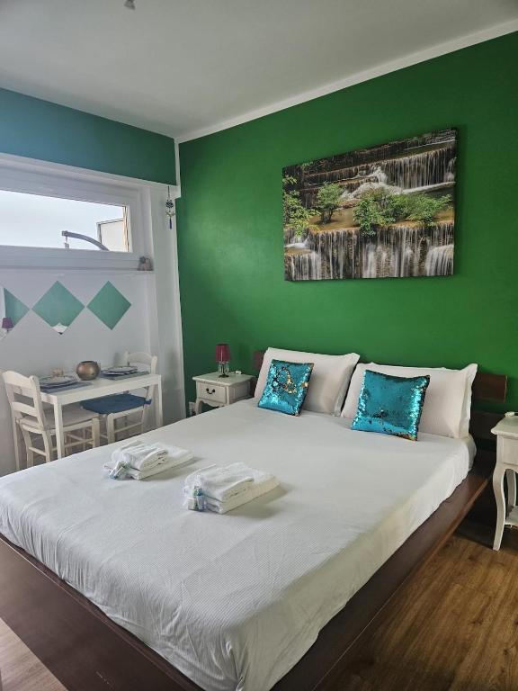 a bedroom with a large bed with a green wall at Tropical Lugano in Lugano