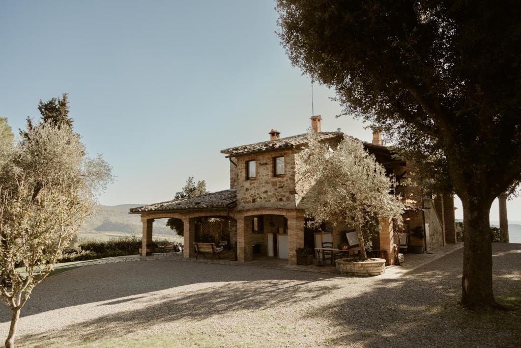 a large stone house with trees in front of it at Il Paliarete in Orvieto