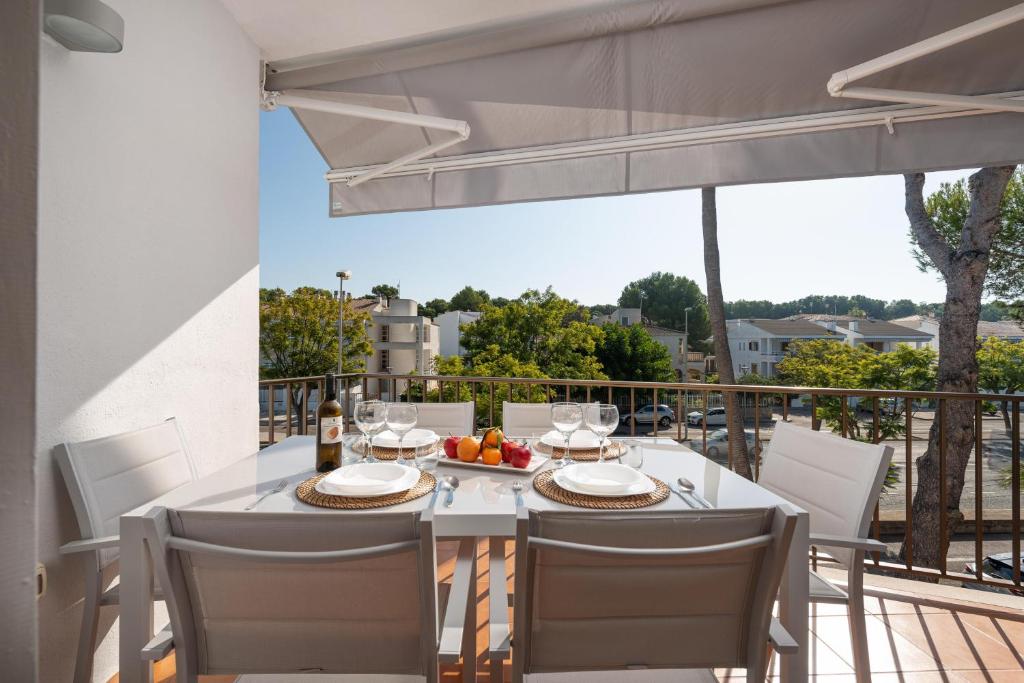 a white table and chairs on a balcony at La Encina in Port d'Alcudia