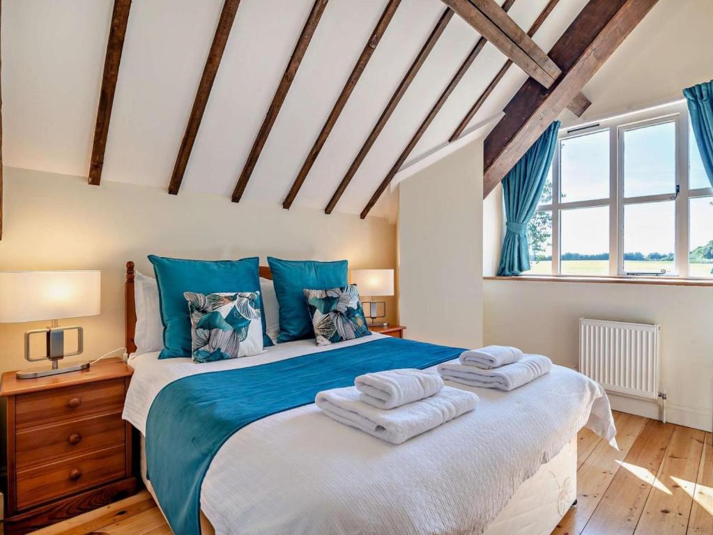 a bedroom with a large bed with towels on it at 2 Bed in Dorchester oc-92416 in Frome Vauchurch