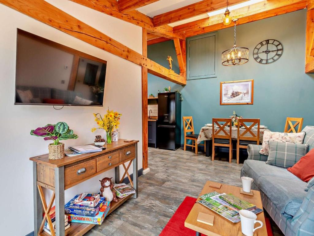 a living room with a couch and a table at 2 Bed in Ripon oc-94559 in Masham