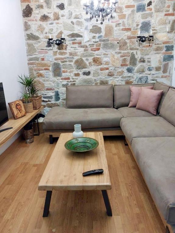 a living room with a couch and a coffee table at Angel's Luxury Studio in Olympiada