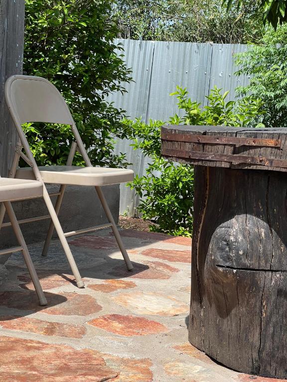 a white chair sitting next to a wooden stump at Mara oasis in Mara Simba
