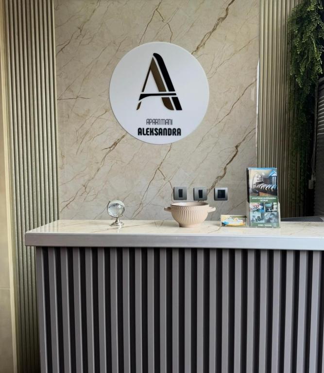 a sign on the counter of a bathroom museum at Apartments Aleksandra Cetinje in Cetinje