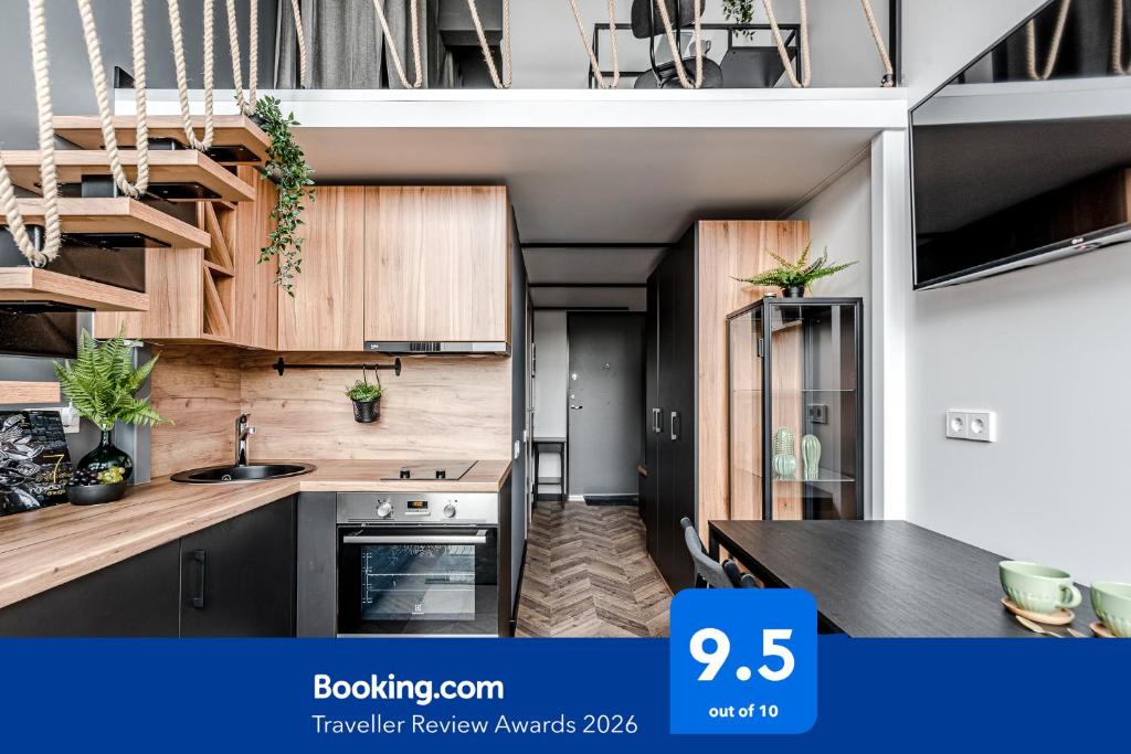 a kitchen with wooden cabinets and a sink at Modern Urban loft in Vilnius