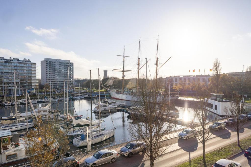 a marina with boats and cars parked in it at Mercator 0301 in Ostend
