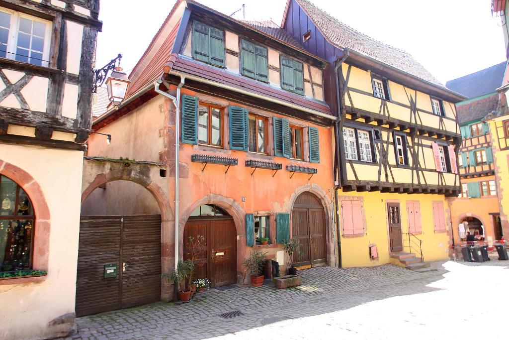 an alley in a medieval town with buildings at Riquewihr in Riquewihr