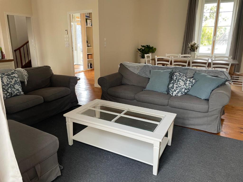 a living room with a couch and a coffee table at Maison de ville in Lannion